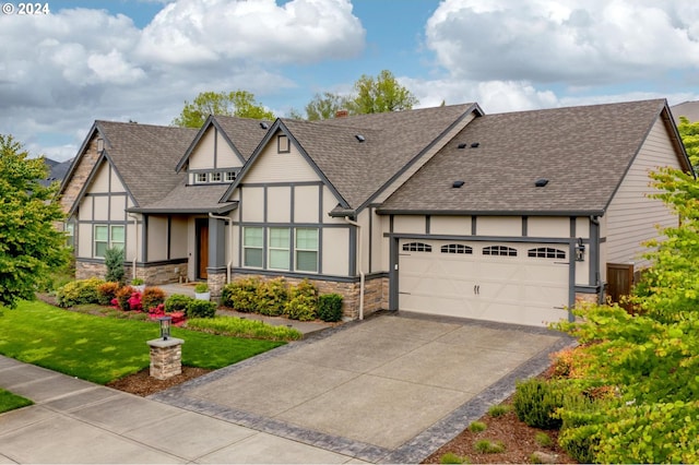 tudor-style house featuring a front yard