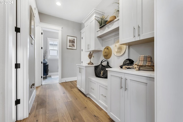 corridor with light hardwood / wood-style flooring