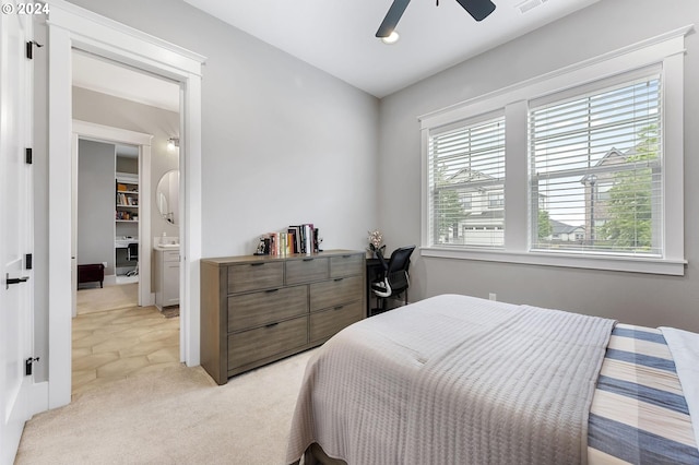 bedroom with ceiling fan, light colored carpet, and multiple windows