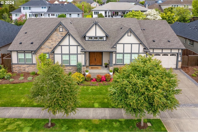 tudor home featuring a front lawn