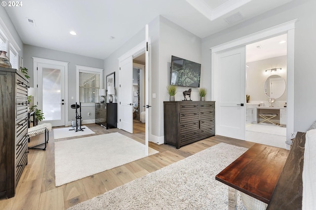 interior space with light wood-type flooring and ensuite bath