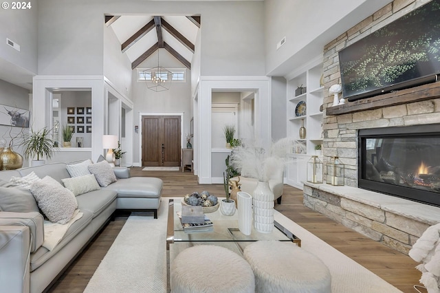 living room featuring dark hardwood / wood-style flooring, high vaulted ceiling, and built in features