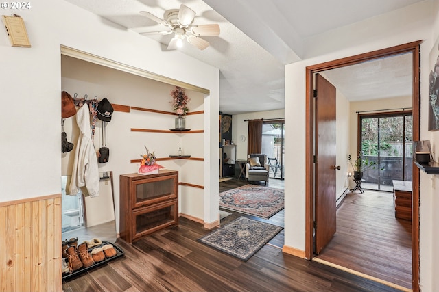 hall featuring a textured ceiling and dark hardwood / wood-style floors