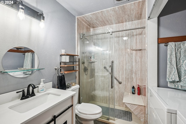 bathroom with a shower with door, vanity, and toilet