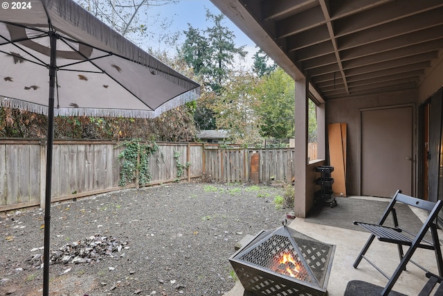 view of patio with an outdoor fire pit