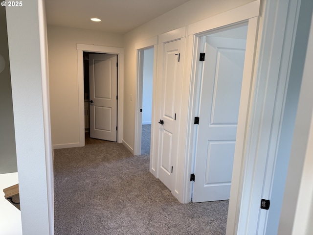 hallway featuring light colored carpet