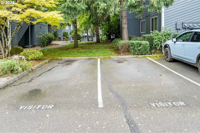 view of vehicle parking featuring a lawn