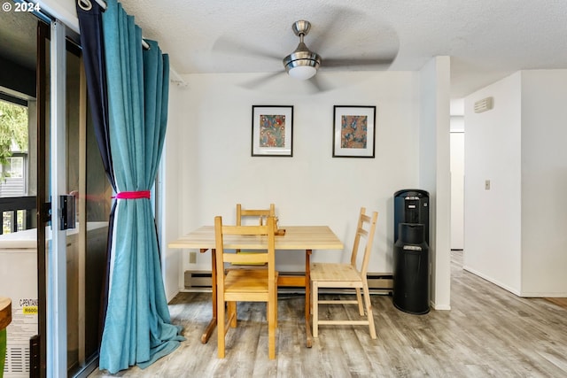 dining space featuring ceiling fan, a textured ceiling, and hardwood / wood-style floors