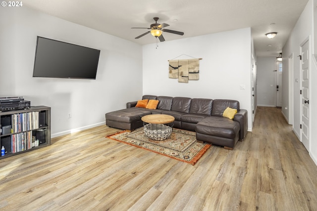 living room featuring ceiling fan and light wood-type flooring