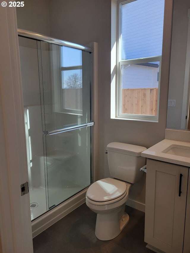 bathroom featuring toilet, a stall shower, and vanity