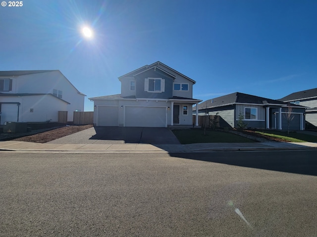 traditional home with a garage, driveway, and fence