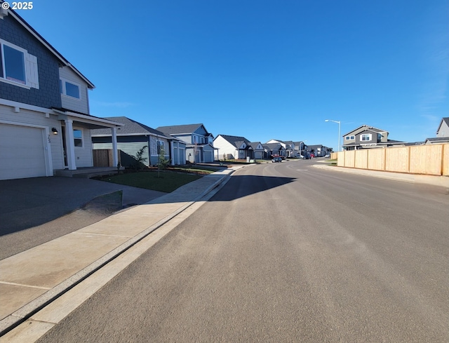 view of street featuring street lighting, a residential view, and sidewalks