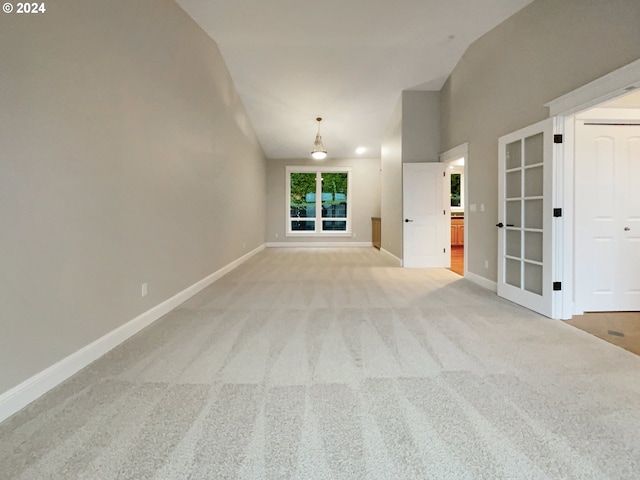11574 SE Ross Rd, Happy Valley, OR 97086 - spare room with light colored carpet, baseboards, and high vaulted ceiling