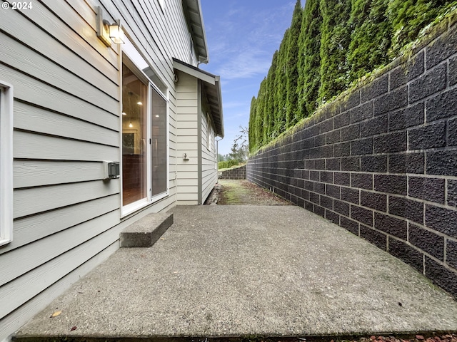 view of side of property with a patio