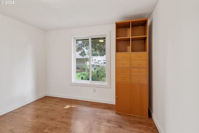 unfurnished bedroom with hardwood / wood-style floors