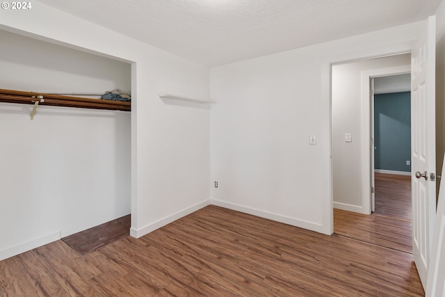 unfurnished bedroom with wood-type flooring