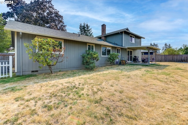 view of front of house with a front yard and a patio area