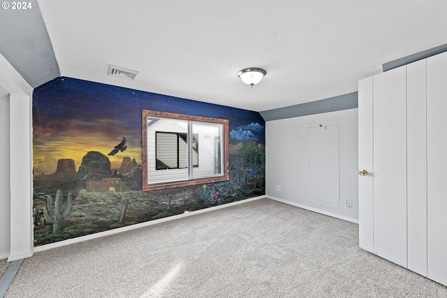 unfurnished bedroom with lofted ceiling and light carpet