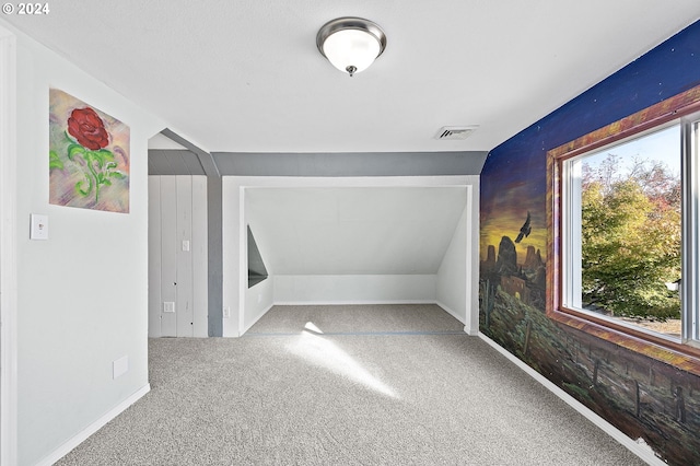 additional living space featuring carpet floors