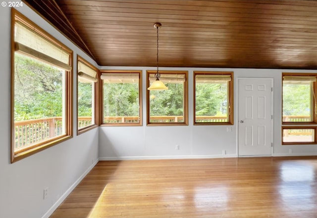 unfurnished sunroom featuring lofted ceiling and wooden ceiling