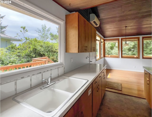 kitchen with a wall mounted air conditioner, decorative light fixtures, sink, dark hardwood / wood-style flooring, and wooden ceiling