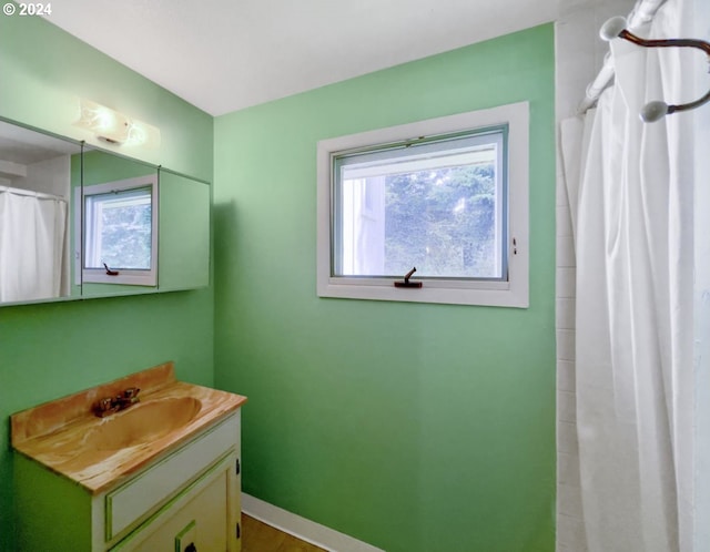 bathroom with vanity, curtained shower, and a wealth of natural light