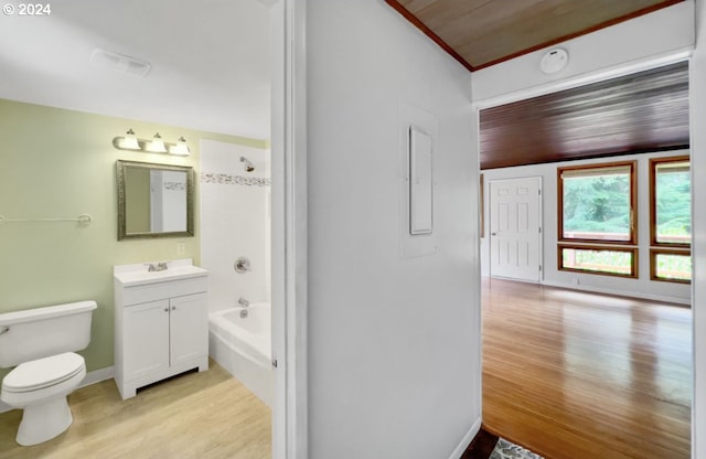 full bathroom featuring hardwood / wood-style floors, tiled shower / bath combo, vanity, wooden ceiling, and toilet