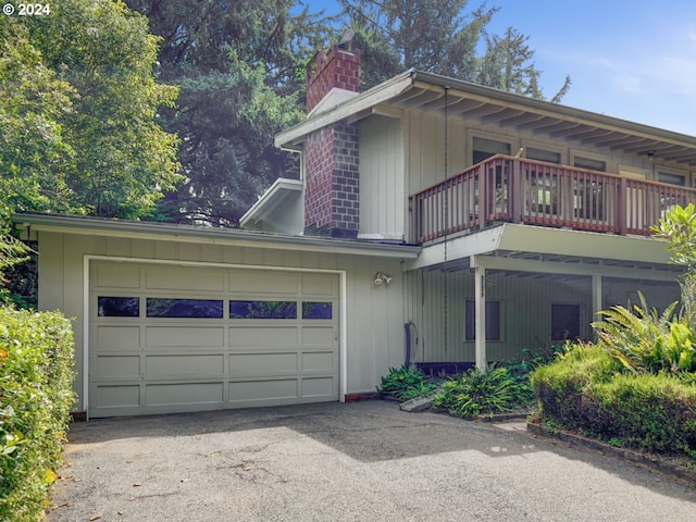 view of front of house featuring a balcony and a garage