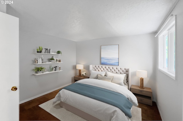 bedroom with dark wood-type flooring