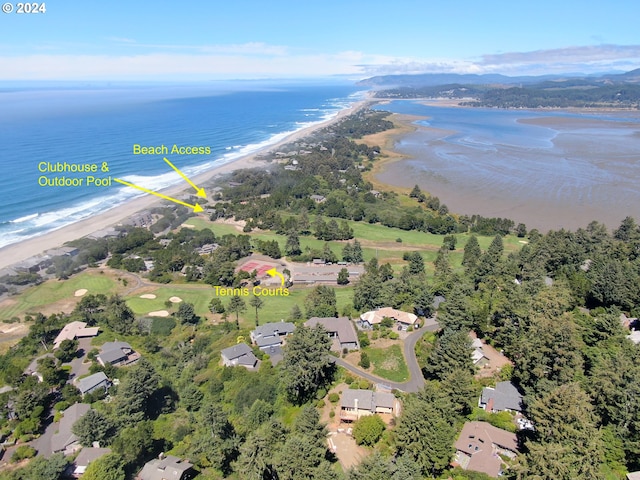 birds eye view of property featuring a beach view and a water view