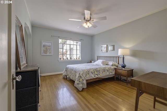 bedroom featuring ornamental molding, ceiling fan, and light wood-type flooring