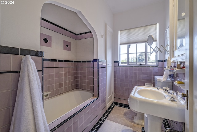 bathroom featuring tiled shower / bath combo, tile walls, and tile patterned floors