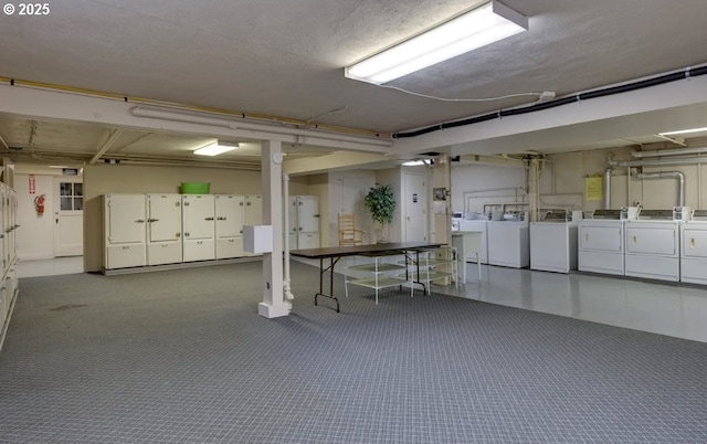 basement featuring dark carpet and washer and dryer