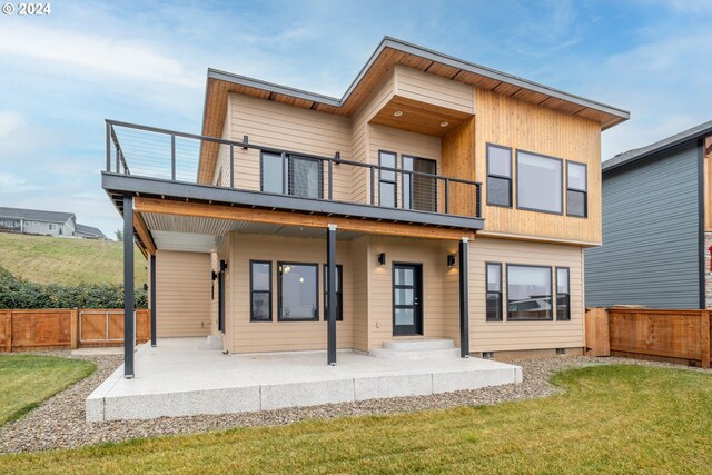 back of house featuring a balcony, a yard, and a patio