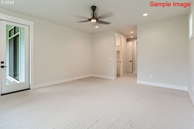 carpeted empty room featuring a healthy amount of sunlight and ceiling fan