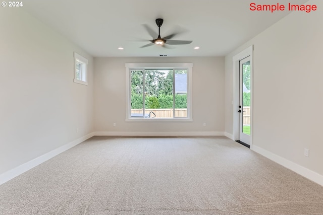 carpeted empty room featuring ceiling fan