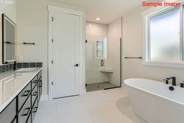 bathroom featuring shower with separate bathtub and vanity