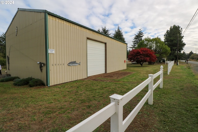 view of outbuilding with a lawn and a garage