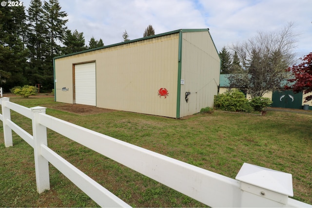 view of outbuilding featuring a garage and a yard