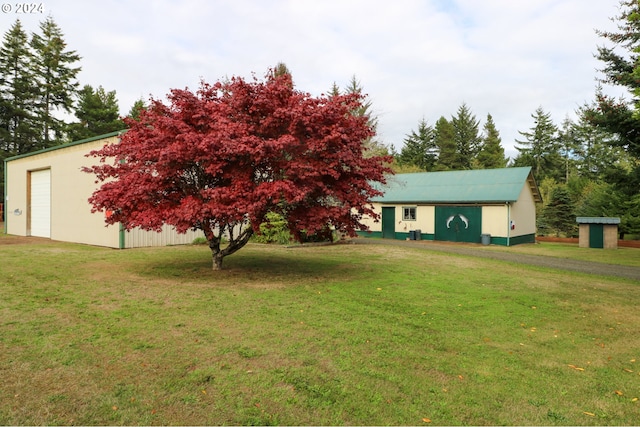 view of front of property with a front lawn and an outbuilding