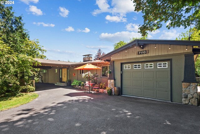 ranch-style home featuring a carport and a garage