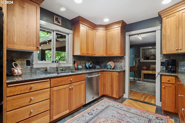 kitchen with sink, light hardwood / wood-style flooring, dishwasher, and decorative backsplash