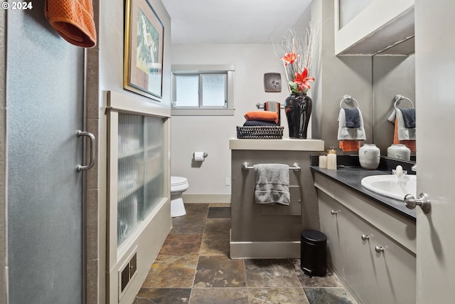 bathroom featuring tile patterned floors, vanity, and toilet