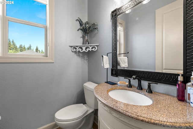 bathroom featuring toilet and vanity