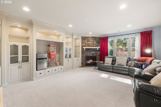 living room with a fireplace, light colored carpet, built in features, and ornamental molding