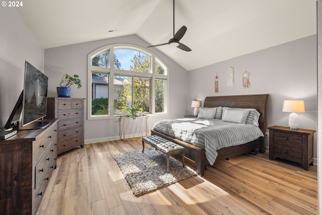 bedroom with lofted ceiling, ceiling fan, and light hardwood / wood-style flooring