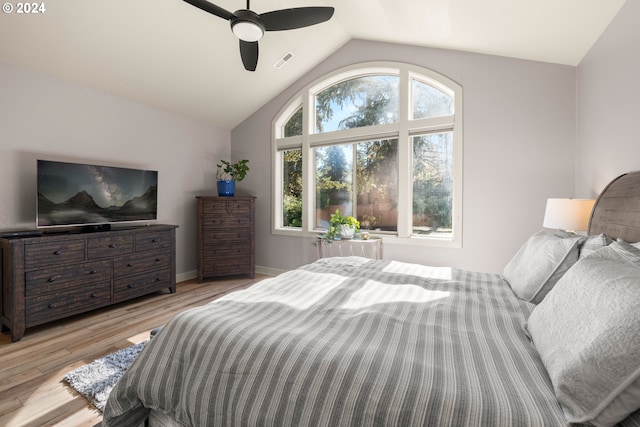 bedroom with ceiling fan, multiple windows, light hardwood / wood-style flooring, and lofted ceiling