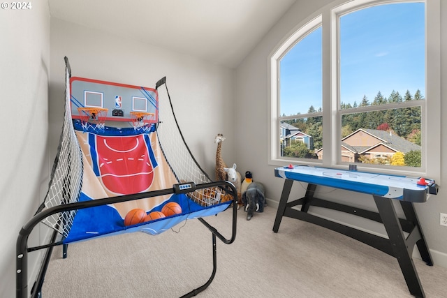 playroom featuring lofted ceiling and light carpet