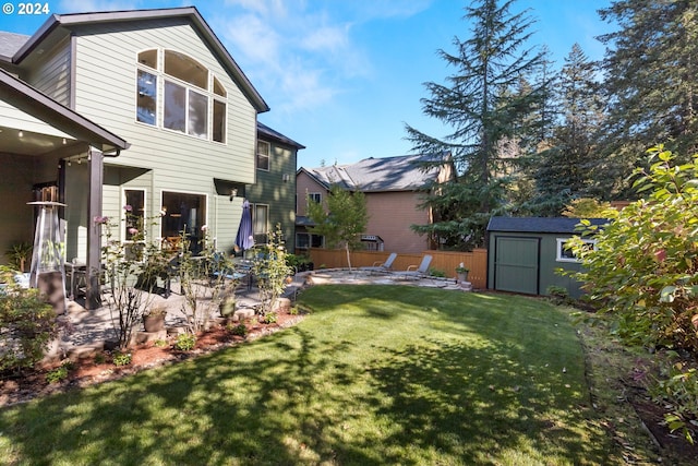 view of yard featuring a storage shed and a patio