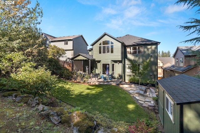 back of house featuring a lawn and a patio area